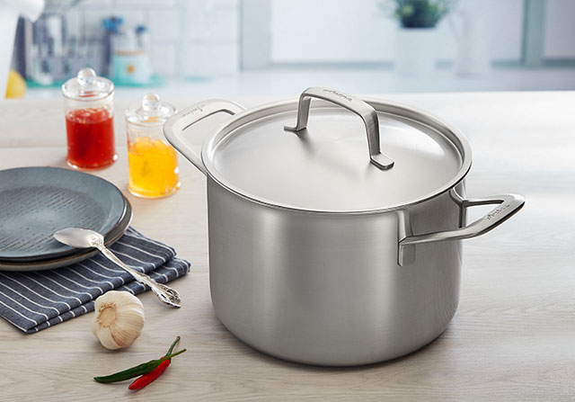 How should kitchen cookware be properly disinfected?